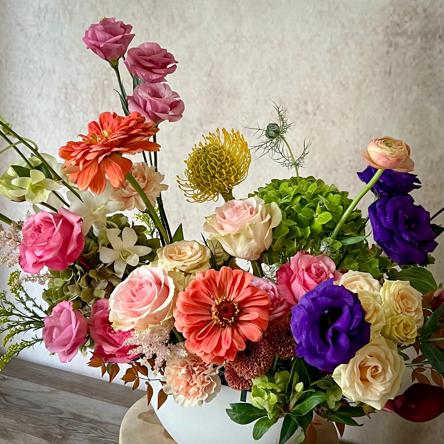 Close-up of seasonal fall flowers with rich orange, yellow, and burgundy hues – ideal for fall decor or gifting.