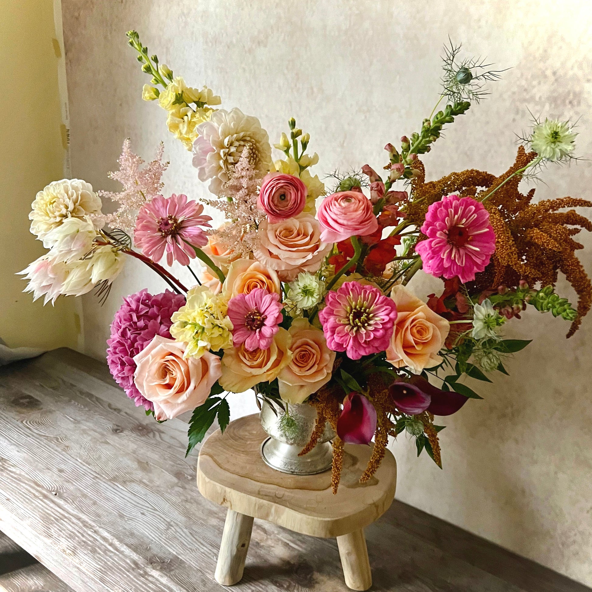 Elegant fall flower arrangement in a vase, showcasing autumn colors for a festive table centerpiece or thoughtful gift.